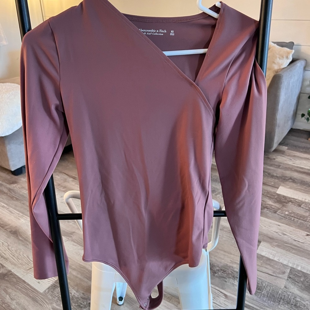Abercrombie and Fitch Mauve thong bodysuit with unique neckline.